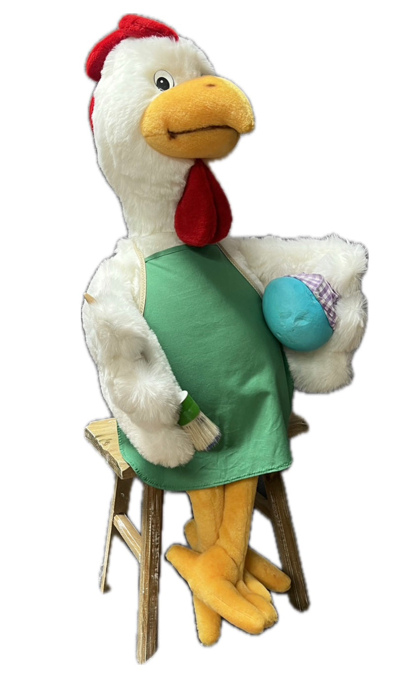 Huhn mit grüner Schürze und Ei