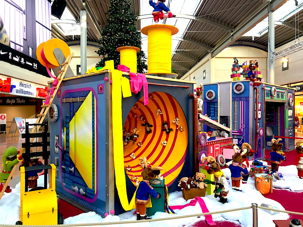 Rudis Rentiertrupp verpackt Weihnachtsgeschenke mit einer großen Maschine